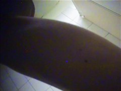 A suntanned girl is wiping her sexy body after shower