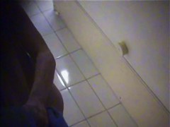 A suntanned girl is wiping her sexy body after shower