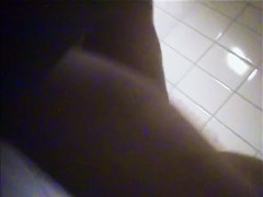 A suntanned girl is wiping her sexy body after shower