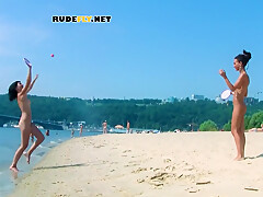 An Adorable Nudist Girls Strolls Around On The Beach And Lies Down