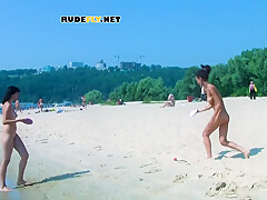 An Adorable Nudist Girls Strolls Around On The Beach And Lies Down