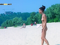 An Adorable Nudist Girls Strolls Around On The Beach And Lies Down