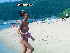 An Adorable Nudist Girls Strolls Around On The Beach And Lies Down