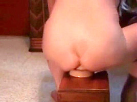 Blonde MILF filling her asshole with a plug
