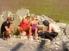 Blondes piss on slave men in kinky outdoor scene