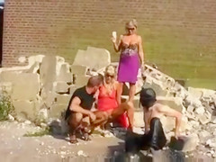 Blondes piss on slave men in kinky outdoor scene