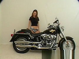 Brunette Terri shows her ass posing on a motorcycle and gets naked