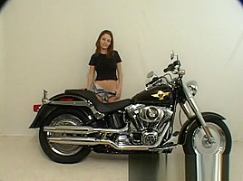 Brunette Terri shows her ass posing on a motorcycle and gets naked