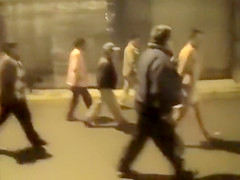 Cops walk a nearly naked criminal down the street