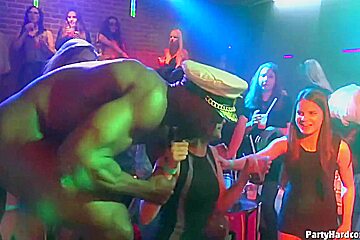 Dark haired woman is kneeling in front of her horny guy and sucking his cock, during a party