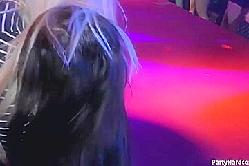 Dark haired woman is kneeling in front of her horny guy and sucking his cock, during a party