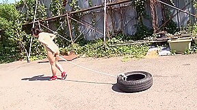 Fit Japanese girl flexes and shows off her strength outdoors