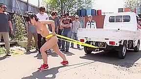 Fit Japanese girl flexes and shows off her strength outdoors