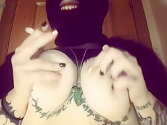 Girl With A Mask Plays With Her Tits And Smokes A Cigarette