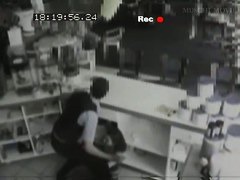 Security cam footage of a sexy brunnette giving head in a store
