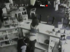 Security cam footage of a sexy brunnette giving head in a store