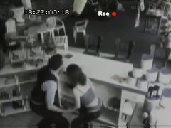 Security cam footage of a sexy brunnette giving head in a store