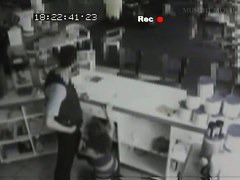Security cam footage of a sexy brunnette giving head in a store