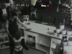 Security cam footage of a sexy brunnette giving head in a store