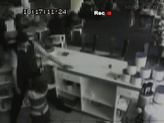 Security cam footage of a sexy brunnette giving head in a store