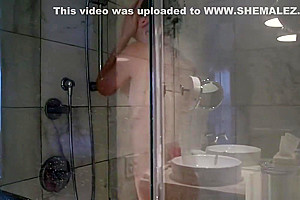 Smalltitted tranny showering while filmed