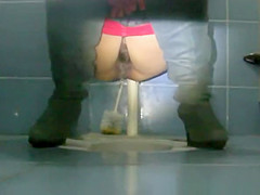 Woman with hairy pussy pissing